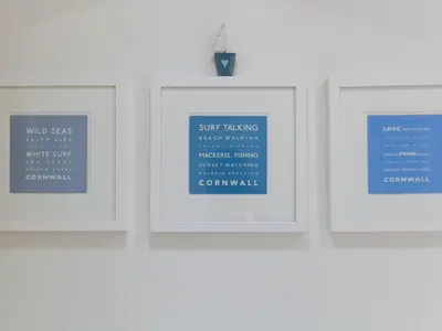 four framed pictures hanging on a wall at Crystal Bay in St Ives
