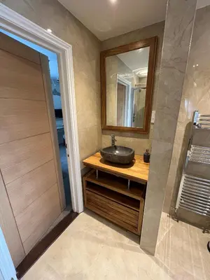 a bathroom with a sink and a mirror at Hewas Water House - Private Pool, Hot Tub & Games Room in Grampound