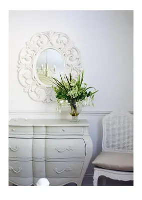 a vase of flowers on a dresser with a mirror at Hewas Water House - Private Pool, Hot Tub & Games Room in Grampound