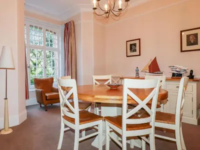 a dining room with a wooden table and chairs at Lewarne in Boscastle