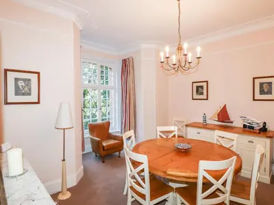 a dining room with a table and chairs at Lewarne in Boscastle