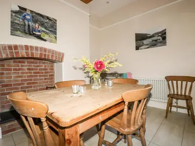 a dining room with a wooden table and chairs at Lewarne in Boscastle