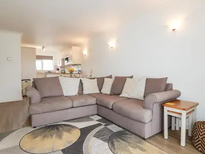 a living room with a couch and a table at 7 Europa Court in Newquay