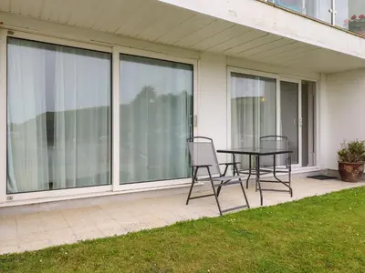 a patio with a table and two chairs on it at 7 Europa Court in Newquay