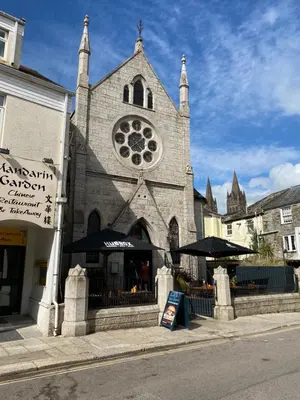 a building with a church with a clock tower at Apartment No 8 - Stay in style in the heart of the Cathedral City. in Truro