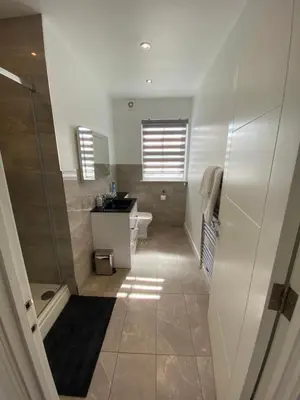 a bathroom with a shower and a sink and a toilet at Apartment No 8 - Stay in style in the heart of the Cathedral City. in Truro