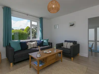 a living room with a couch and a table at Brynmaur in St Ives