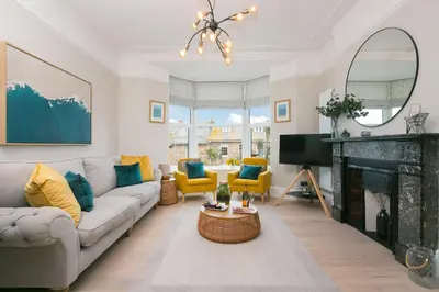 a living room with a couch and a fireplace at Summer Salt in St Ives