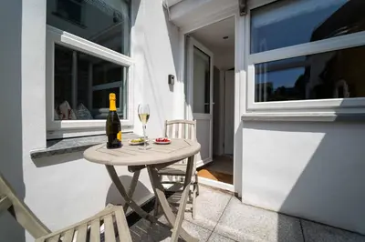 a table with a bottle of wine and a glass at Summer Salt in St Ives