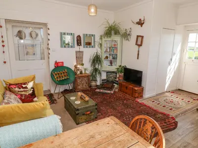 a living room with a couch and a tv at The Cottage in Penzance