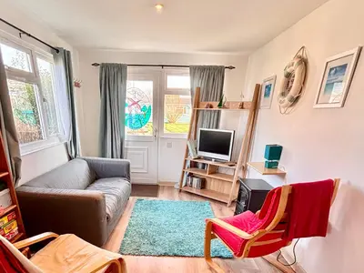 a living room with a couch and a tv at Trevone - Chalet 130 in Padstow