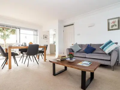 a living room with a couch and a table at The Wesley Apartment in Falmouth
