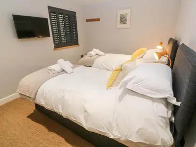 two beds in a room with white pillows at Postcard Lodge in Fowey