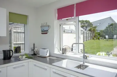 a kitchen with a sink and a window at Little Close - Sea Views - Parking For 3 Cars - BBQ Area in Newquay