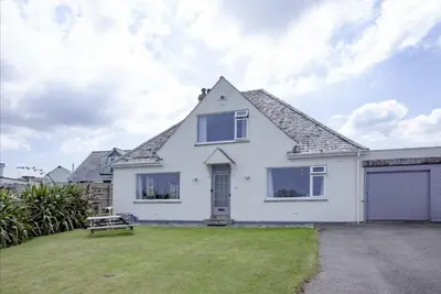 a white house with a large yard at Little Close - Sea Views - Parking For 3 Cars - BBQ Area in Newquay
