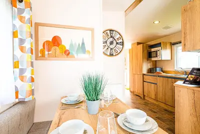 a kitchen with a wooden table with dishes on it at The Seascape, Padstow in Padstow