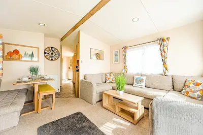 a living room with a couch and a table at The Seascape, Padstow in Padstow