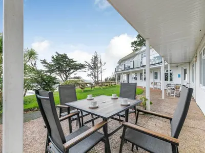 a table and chairs on the patio of a house at Lobster Pot - Mount Brioni in Downderry