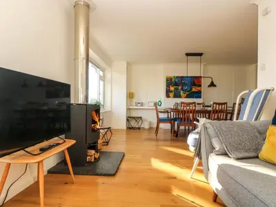 a living room with a couch and a fire place at Rock Pool House in Helston