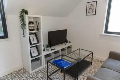 a living room with a tv and a coffee table at Valley View Studio Annexe in Downderry