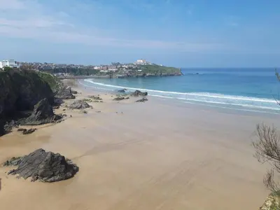 an aerial view of a beach with rocks and the ocean at Nice big 2 double bedroom Apartment in the Town in Newquay