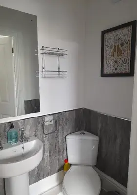 a bathroom with a white toilet and a sink at Lansdowne Simply Stay in Redruth