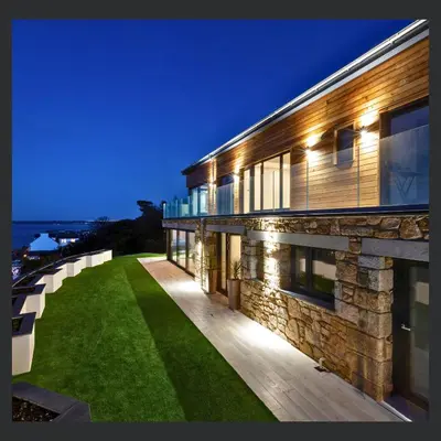 an exterior view of a building with a green lawn at Uno St Ives - Boutique Luxury Accommodation in St Ives