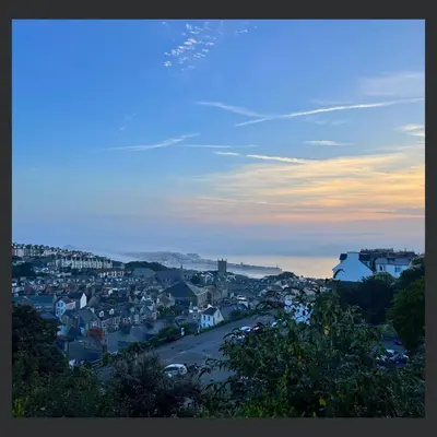 a view of a town at sunset with a city at Uno St Ives - Boutique Luxury Accommodation in St Ives