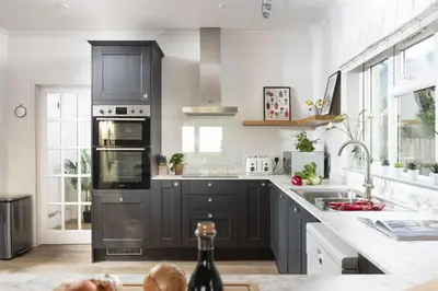 a kitchen with black cabinets and a counter top at Westaway House in Port Isaac