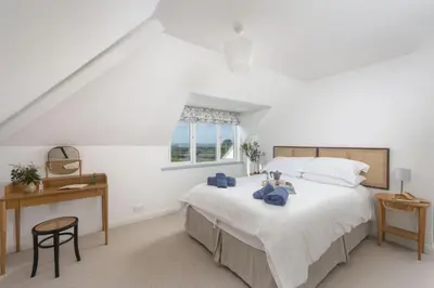 a bedroom with a bed with two teddy bears on it at Westaway House in Port Isaac