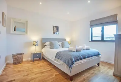 a bedroom with a bed and a window at Birch House in St. Agnes
