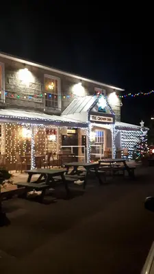a picnic table in front of a building with christmas lights at Crown Inn in Penzance