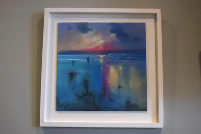 a painting of the ocean in a white frame on a wall at Crown Inn in Penzance