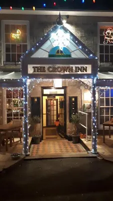 a sign that reads the crown inn with lights at Crown Inn in Penzance