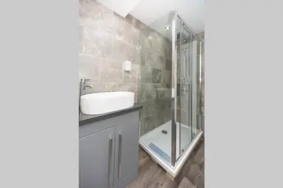 a bathroom with a sink and a shower at Modern House in Looe, Near Beach and Bars with Great Views and free access to a nearby Indoor Swimming Pool in Looe