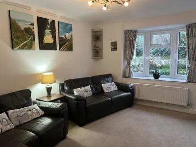 a living room with a couch and a chair at Primrose Cottage in Hayle