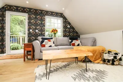 a living room with a couch and a table at Robin's Nest at The Shire Inn in Camborne