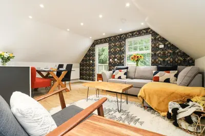a living room with a couch and a table at Robin's Nest at The Shire Inn in Camborne