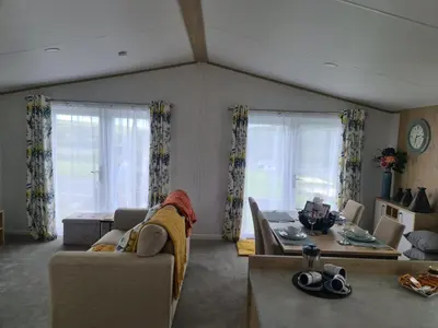 a living room with a couch and a table at Mawgan Pads Mawgan Porth in Mawgan Porth