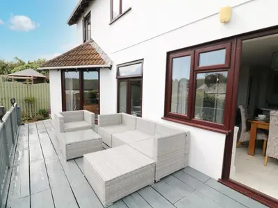 a patio with two chairs and a table at 12 Claremont Falls in Looe