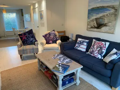 a living room with two couches and a coffee table at Little Karenza is the perfect Cornish getaway in Saint Anthony