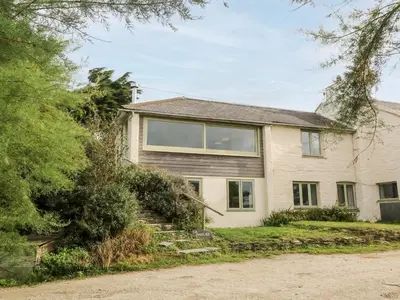 a house with a staircase in front of it at Porth Farm Annexe in Newquay