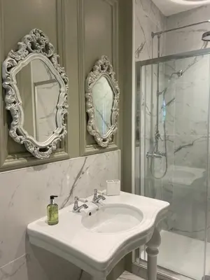 a white bathroom with a sink and a shower at Penarwyn House in Par