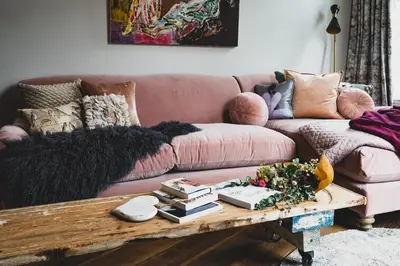 a living room with a pink couch and a coffee table at Host St Ives in St Ives