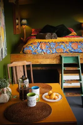 a table with a plate of food on top of a bed at The Bolt Hole in St Merryn