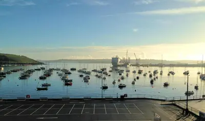 a bunch of boats sitting in a harbor at Headland View. Luxury. Harbour-Front. With Parking in Falmouth
