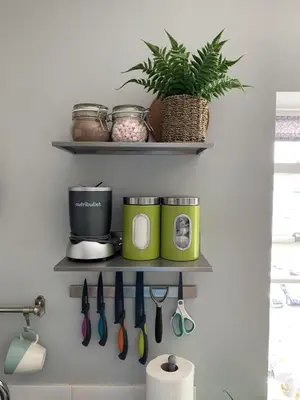 a kitchen shelf with pots and pans and a plant at Headland View. Luxury. Harbour-Front. With Parking in Falmouth