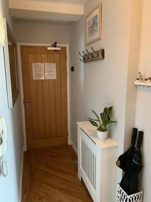 a hallway with a door and a potted plant at Headland View. Luxury. Harbour-Front. With Parking in Falmouth