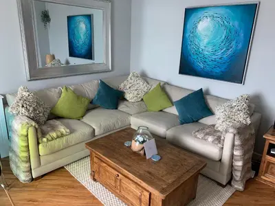 a living room with a couch and a coffee table at Headland View. Luxury. Harbour-Front. With Parking in Falmouth