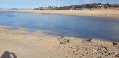 a shadow of a person standing on a beach at Stargazy Shepherds Hut in St Ives